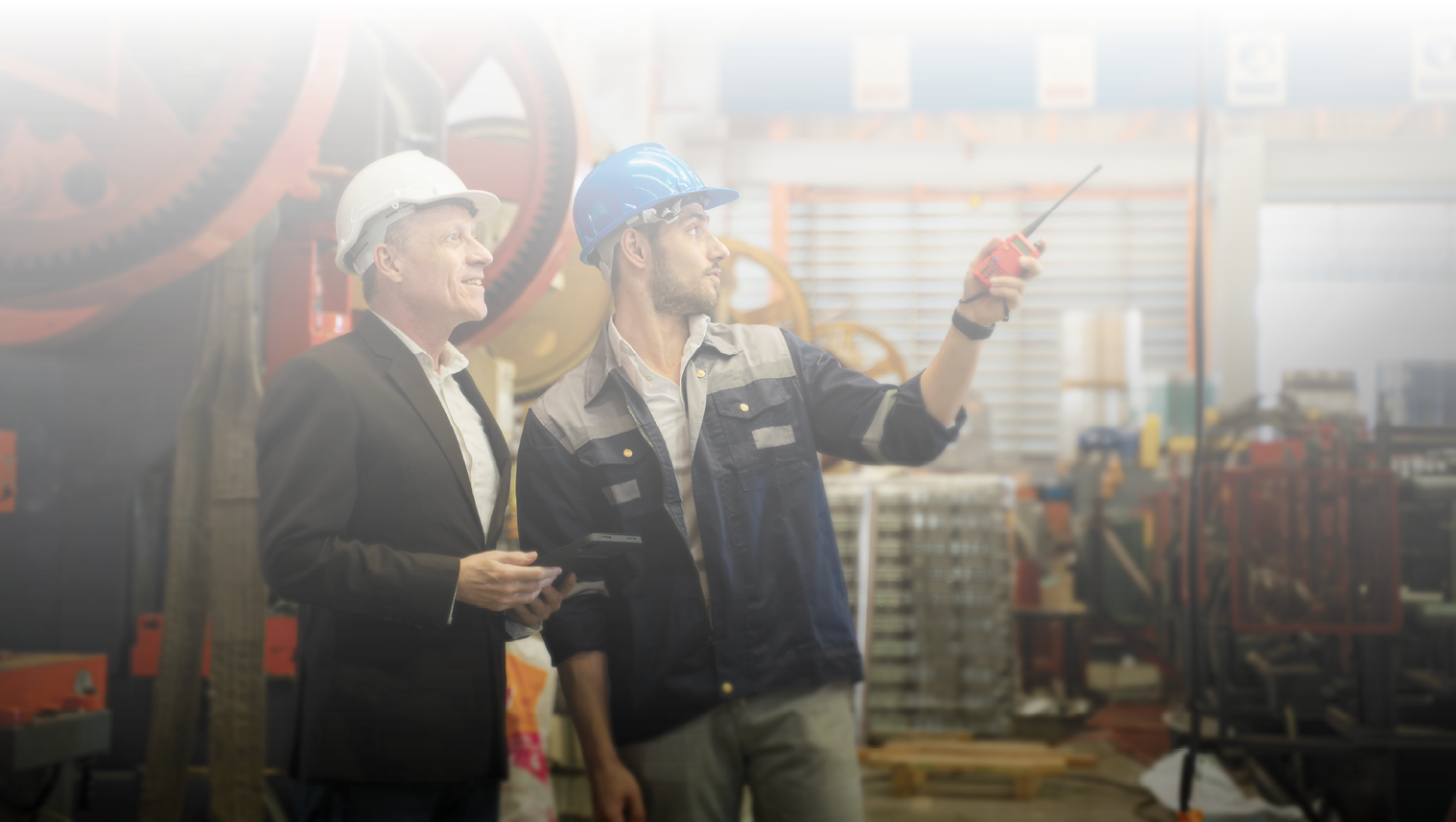 Manager discussing with engineering or worker about machine control and operate in manufacturing plant.